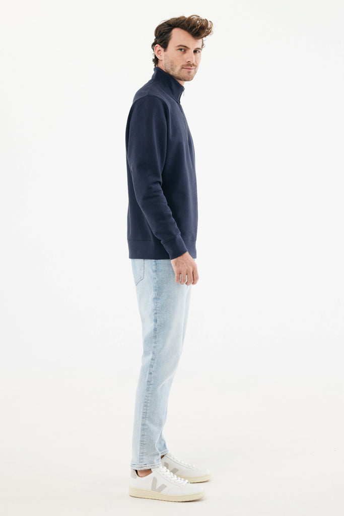 Load image into Gallery viewer, Iqoniq recycled cotton quarter zip sweater, textile product with a close-up of the quarter zip and fabric texture.
