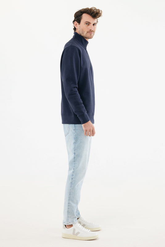 Iqoniq recycled cotton quarter zip sweater, textile product with a close-up of the quarter zip and fabric texture.