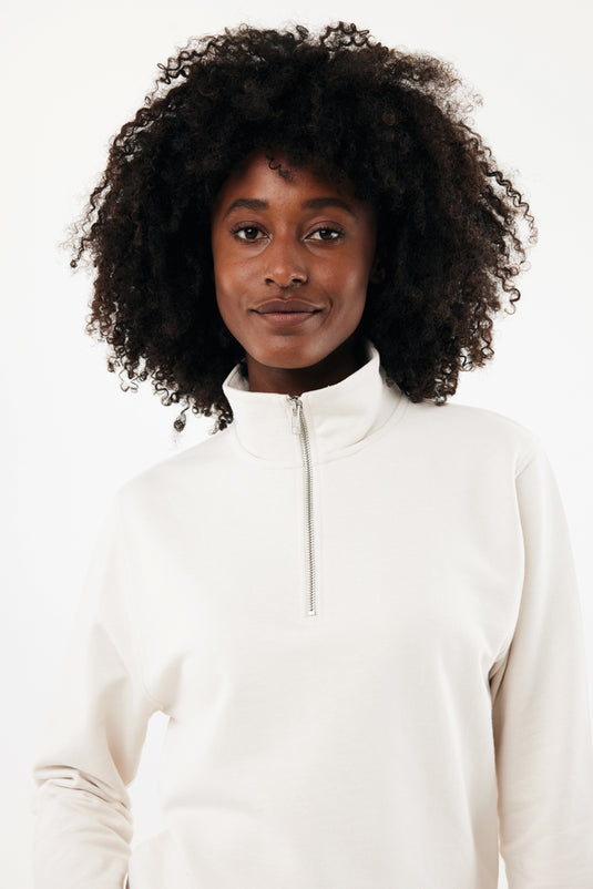 Iqoniq Elgon recycled cotton quarter zip sweater, close-up of green textile with quarter zip detail and textured fabric.