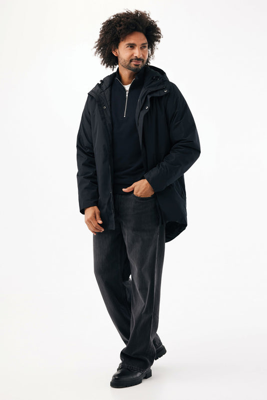 Iqoniq Thelon recycled polyester parka in textile fabric, shown in a front view with hood and zipper detail.