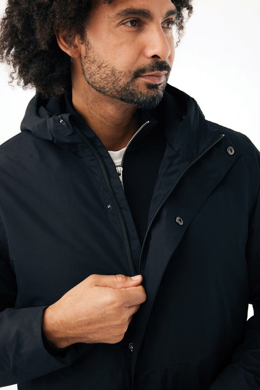 Recycled polyester Thelon parka by iqoniq, showcasing a warm, eco-friendly textile with a hood and full zipper in a neutral color.