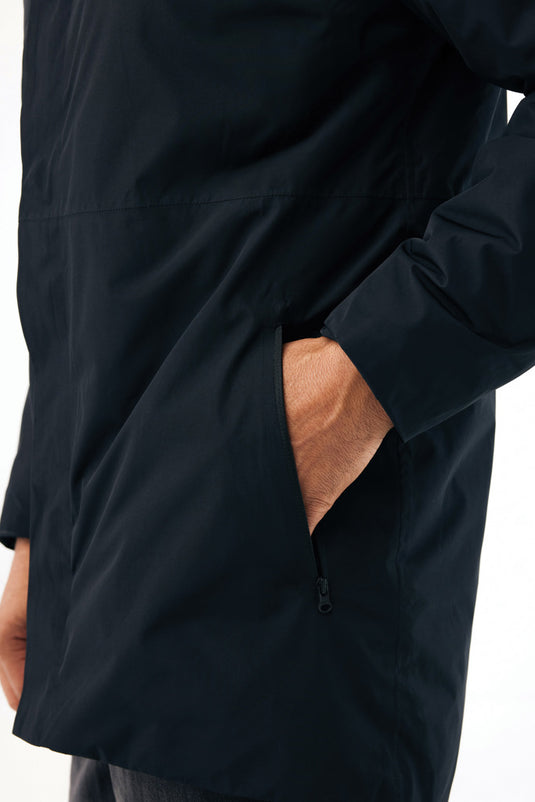Iqoniq Thelon recycled polyester parka, close-up of textile material showing green fabric and textured surface.