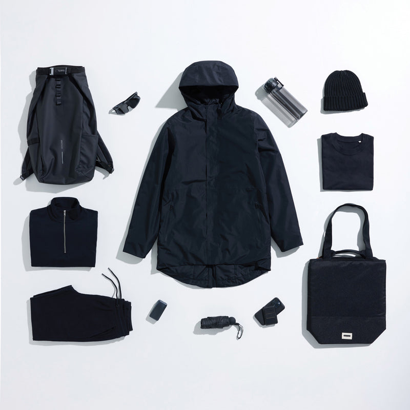 Load image into Gallery viewer, Iqoniq Thelon recycled polyester parka textile in dark gray, showcasing its hood, front zipper, and sleek winter design.
