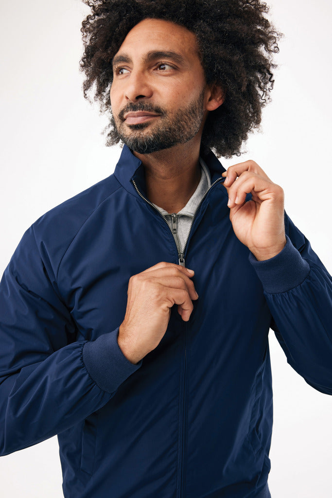 Load image into Gallery viewer, iqoniq Odin recycled polyester urban jacket displayed on a model, showcasing its stylish design and eco-friendly textile fabric.
