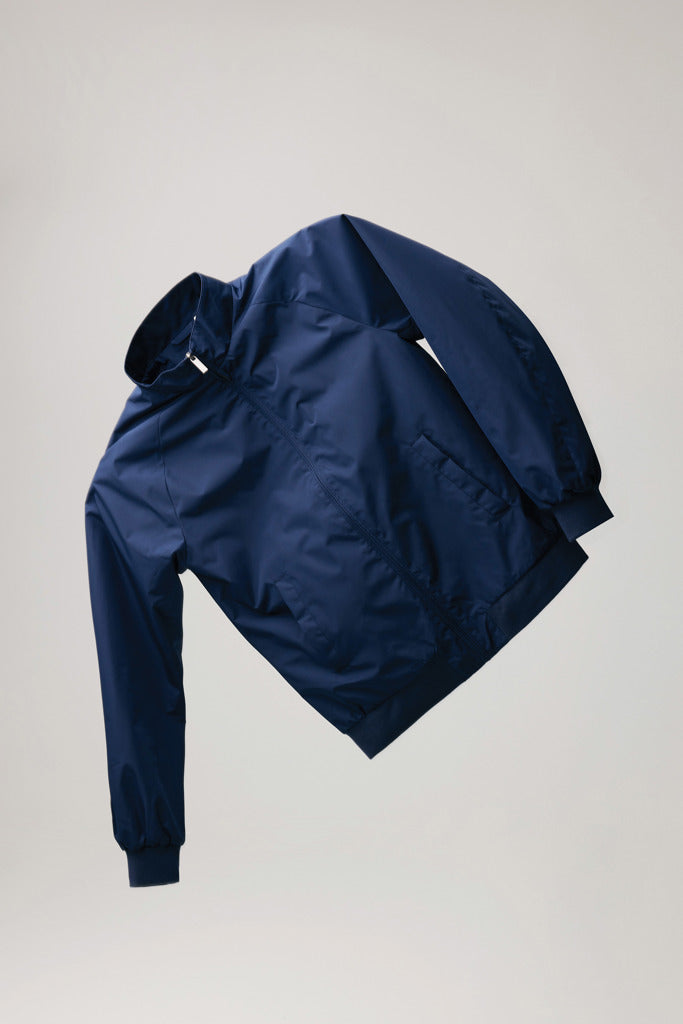 Load image into Gallery viewer, Iqoniq Odin recycled polyester urban jacket hanging on a hanger, showcasing its eco-friendly textile design and modern style.
