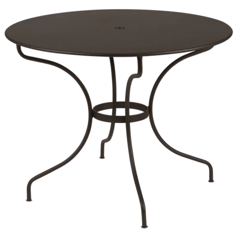 Load image into Gallery viewer, Fermob OPÉRA+ outdoor metal table with 96 cm diameter, suitable for five seating, shown on patio furniture setting.
