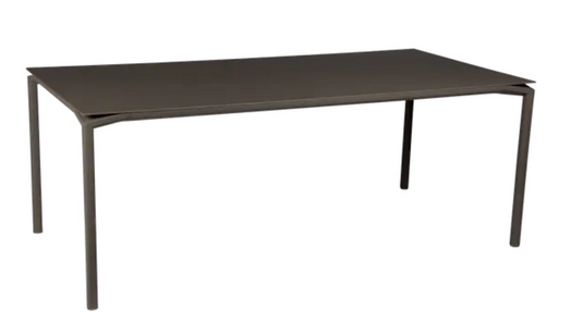 Fermob CALVI outdoor rectangular dining table, 195x95 cm, with eight seats, featuring a sleek modern design and durable surface.