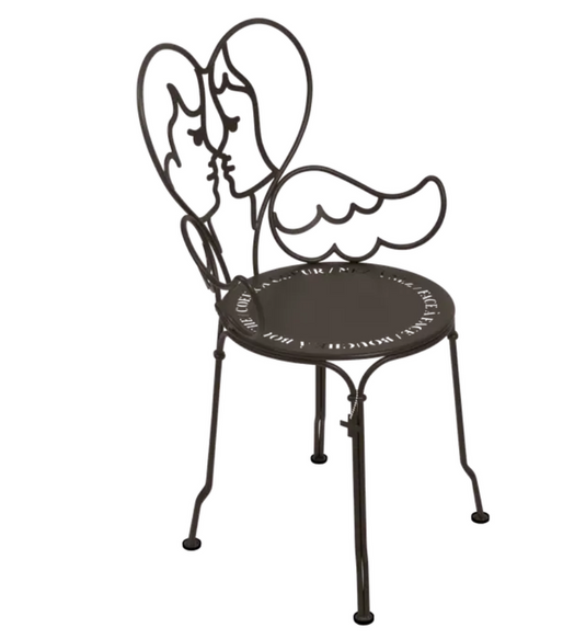 Fermob ANGE metal chair with a sleek, modern design, shown outdoors with a colorful cushion on a patio setting.