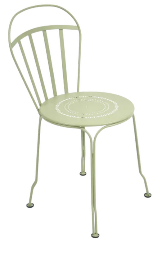 Willow green Fermob Louvre outdoor chair with a sleek metal frame and curved armrests, perfect for garden or patio seating.