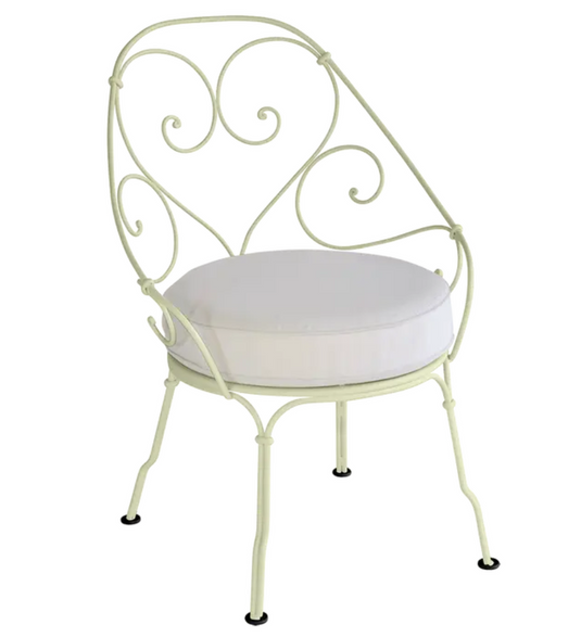 Willow green Fermob Cabriolet outdoor armchair with off-white cushions, metal frame, stylish garden furniture for outdoor relaxation.