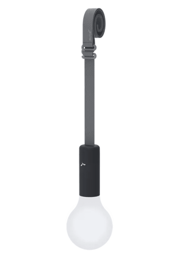 Load image into Gallery viewer, Fermob APLÔ suspended lamp with an anthracite finish and adjustable suspension strap, hanging as a stylish, rechargeable light.
