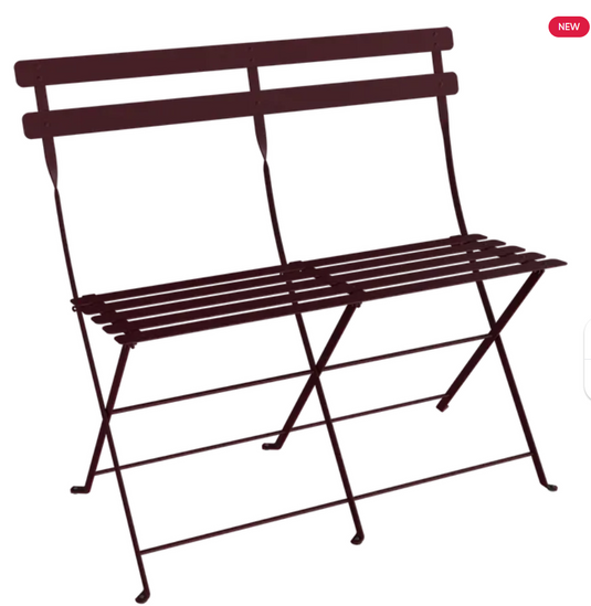 Black cherry Fermob Bistro Two Seater Ottoman, folding bench with cushioned seats, ideal for outdoor or patio use.