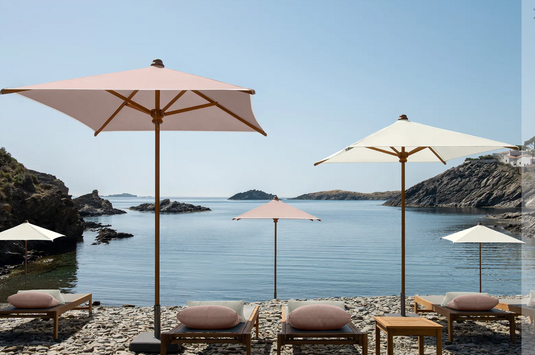 Fermob IBIZA teak outdoor sunlounger with a slatted teak frame, ideal for relaxing on the beach or patio.