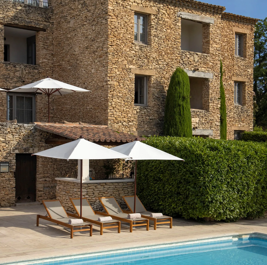 Fermob IBIZA teak sunlounger with a slatted outdoor sun bed design, ideal for relaxing on the beach or patio.