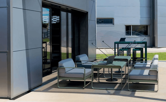 Fermob Bellevie armchair with woven rattan-style seat and backrest, metal frame in a modern outdoor furniture design