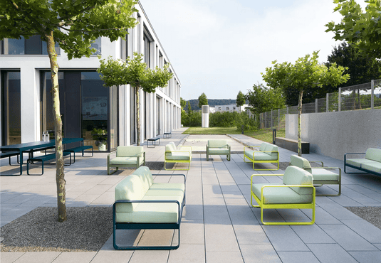 Fermob Bellevie armchair with metal frame and cushioned seat, showcasing its stylish design and comfortable seating.