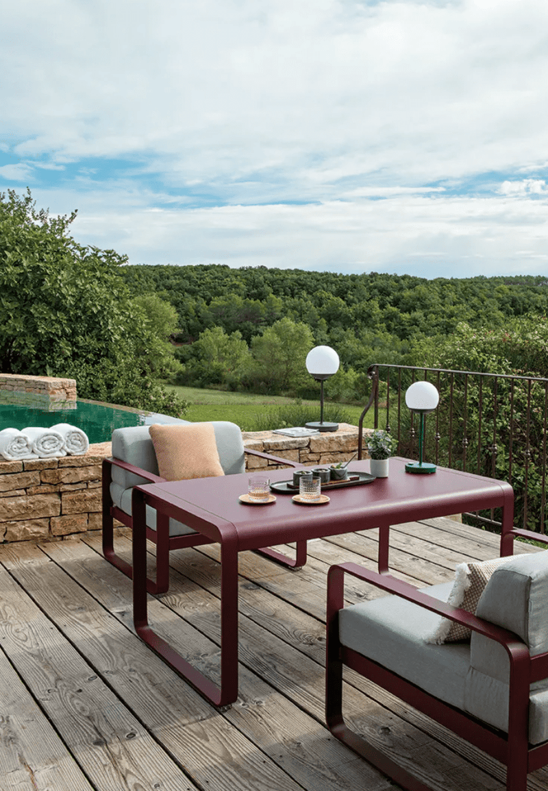 Load image into Gallery viewer, Fermob Bellevie armchair with a sleek metal frame and comfortable cushion, perfect for modern indoor or outdoor seating.
