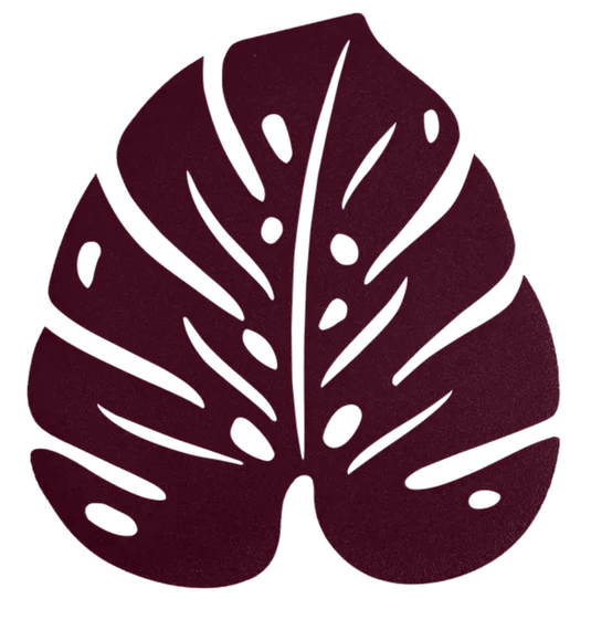 Black cherry Monstera-inspired Fermob non-slip metal pad with a bold floral design for stylish grip and surface protection.