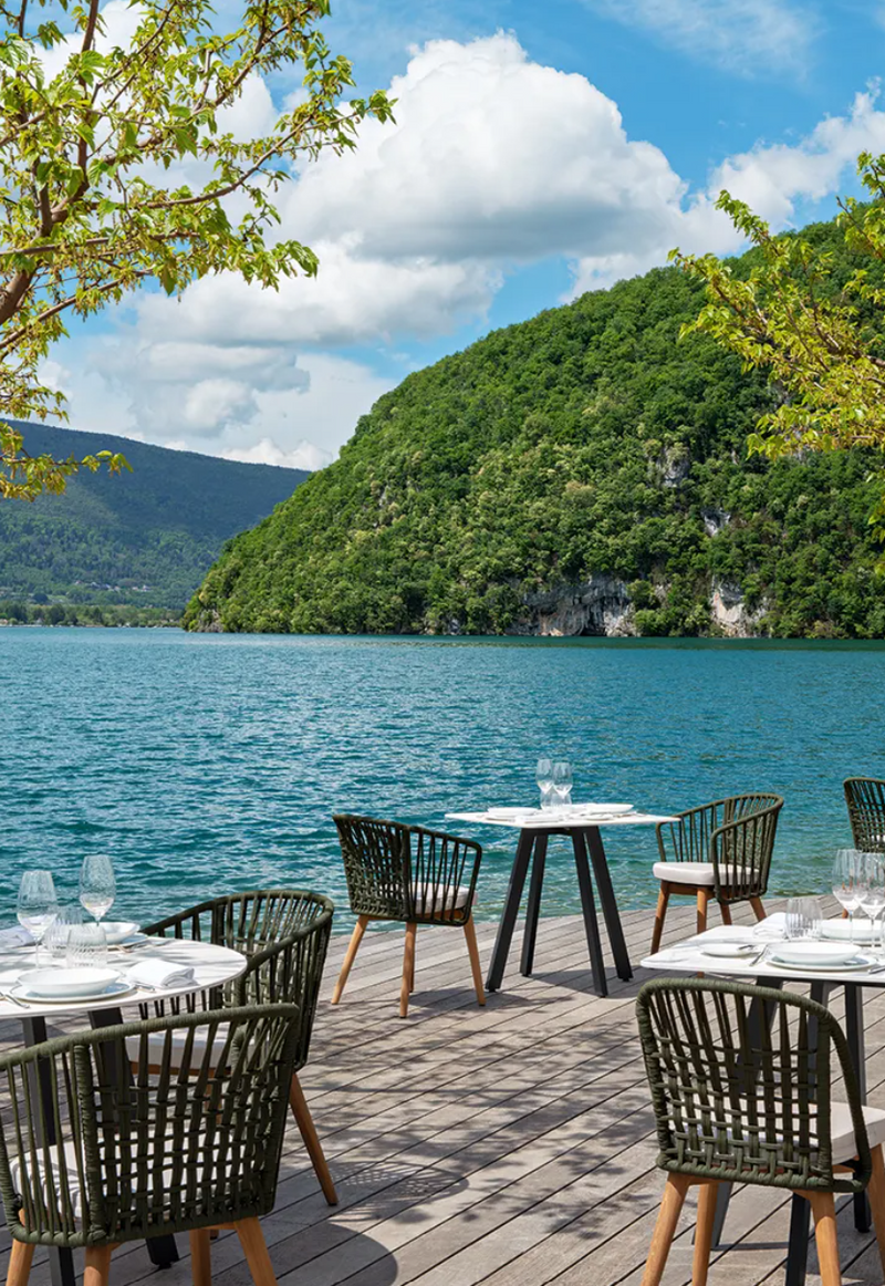 Load image into Gallery viewer, Fermob GORDES luxury teak outdoor chair with cushioned seating, ideal for cafe or patio use, showcasing stylish outdoor furniture.
