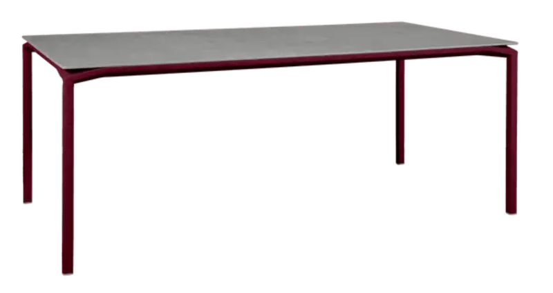 Load image into Gallery viewer, Fermob CALVI Kreta mineral dining table, 195 x 95 cm, black cherry finish, eight-seater with sturdy tabletop for outdoor dining.
