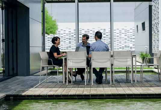 Fermob Calvi outdoor rectangular dining table, 195x95 cm, with eight seats, suitable for outdoor and indoor use.