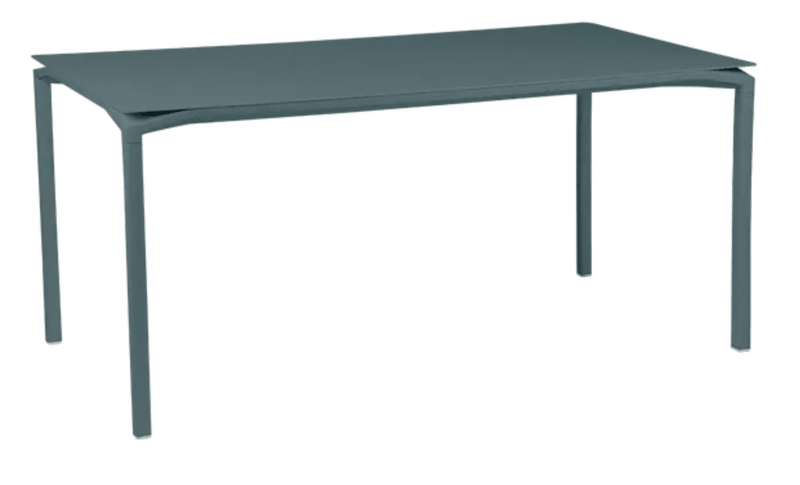 Load image into Gallery viewer, CALVI Rectangular Table 160 x 80 cm Six Seater - Custom Wood DesignsFermob CALVI rectangular kitchen table, 160x80 cm, six-seater with modern design, shown in a stylish outdoor setting.Kitchen Table24575188678071Rosemary
