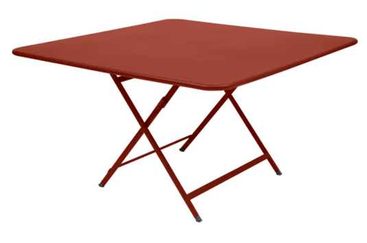 Red Fermob CARACTÈRE foldable outdoor table, 128x128 cm, eight-seater with a vibrant ochre finish, suitable for outdoor dining.