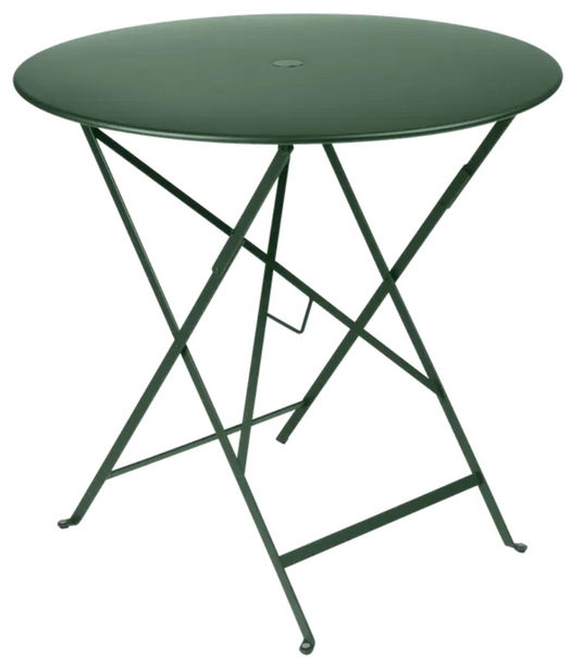 Cedar green Fermob Bistro Table Ø77cm round folding metal outdoor table for cafe or patio use.