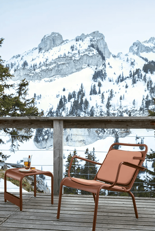 Set of two Fermob Color Mix outdoor cushions, 41x45 cm, featuring vibrant, mixed color patterns on a patio chair.