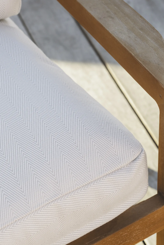 Fermob Lodge outdoor teak armchair with low arms, ideal for hotel terrace seating, showcasing a stylish and comfortable design.