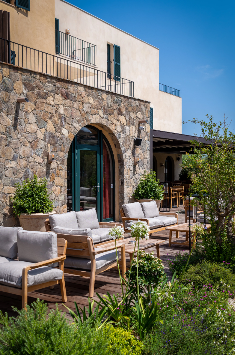 Load image into Gallery viewer, Fermob Lodge outdoor teak armchair with low armrests, suitable for hotel terrace seating, featuring a stylish and durable design.
