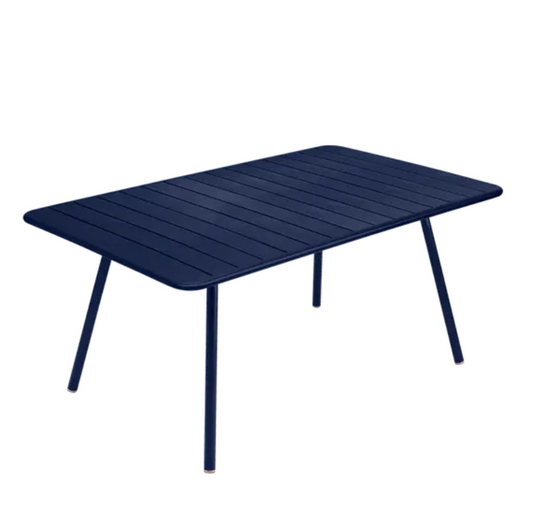 Deep blue Fermob Luxembourg metal outdoor table, 165 x 100 cm, showing the sleek tabletop and sturdy metal legs.