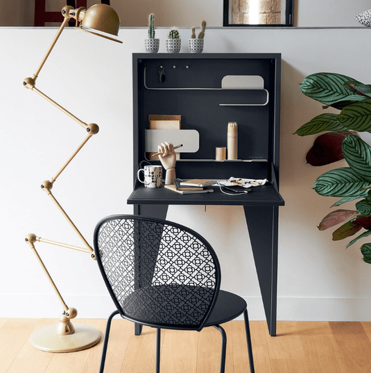 Wall-mounted Fermob Face à Face writing desk with a honey-colored wooden surface and sleek modern design.