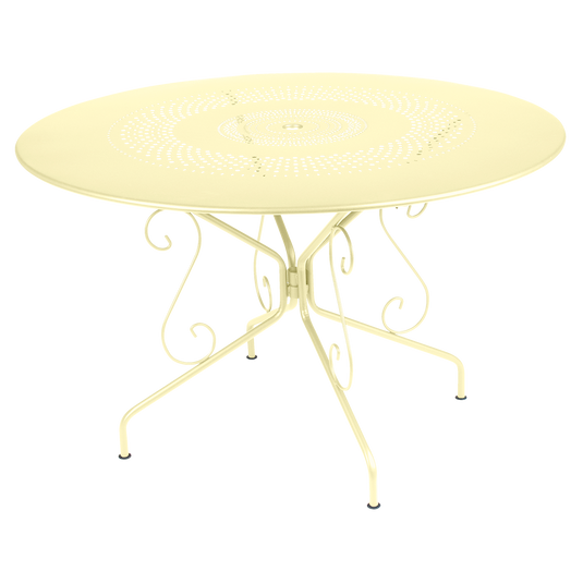 Fermob Montmartre Table Ø117 cm in Frosted Lemon – large round perforated steel garden table Ø 117 cm