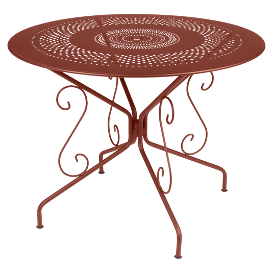 Fermob Montmartre Table Ø96 cm in Red Ochre – round perforated steel garden table Ø 96 cm