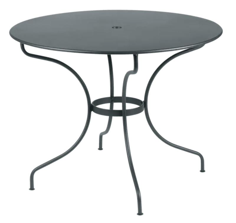 Load image into Gallery viewer, Fermob OPÉRA+ outdoor metal table in Storm Grey, 96 cm diameter, suitable for five-seater patio or garden space.

