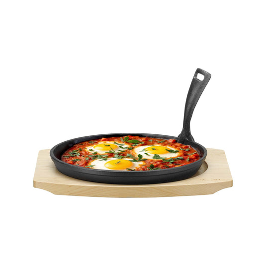 Cast iron serving pan with wooden base and handle, 220mm diameter, by Fine Dine, shown with a rustic presentation.
