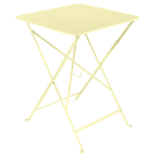Bright yellow Fermob foldable bistro table with frosted lemon finish, 57x57 inches, ideal for outdoor café and patio use.
