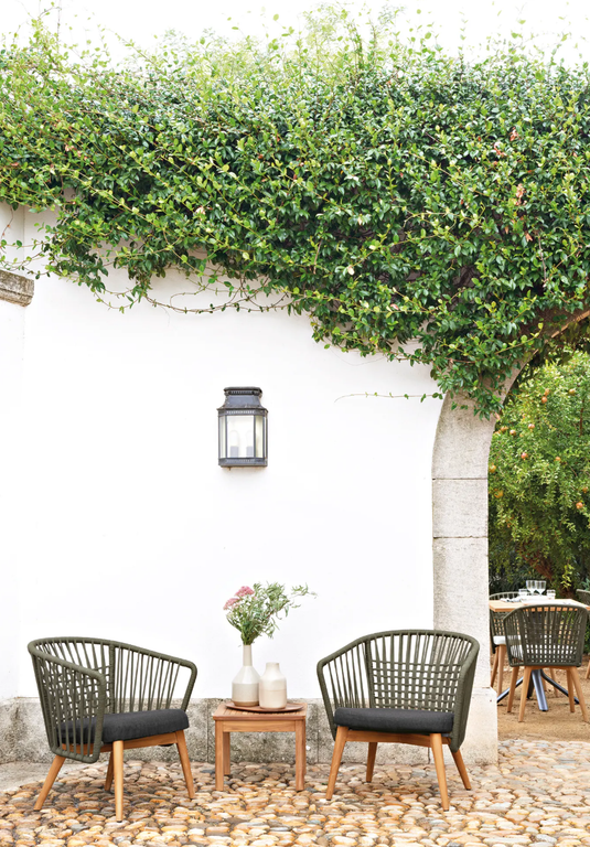 Fermob GORDES low teak outdoor armchair with sleek design and natural wood finish, ideal for patio or garden seating.