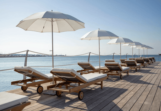 Fermob IBIZA teak outdoor sunlounger with a slatted frame, ideal for relaxing on the beach or patio in Ireland