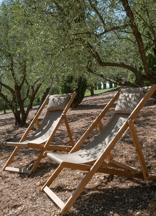 Fermob IBIZA teak deckchair with woven seat and backrest, sturdy wooden frame, perfect for outdoor lounging or patio relaxation.
