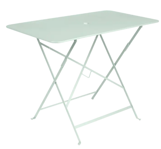Light green Fermob metal foldable bistro table, 97x57 cm, ideal for outdoor cafes and small dining spaces.