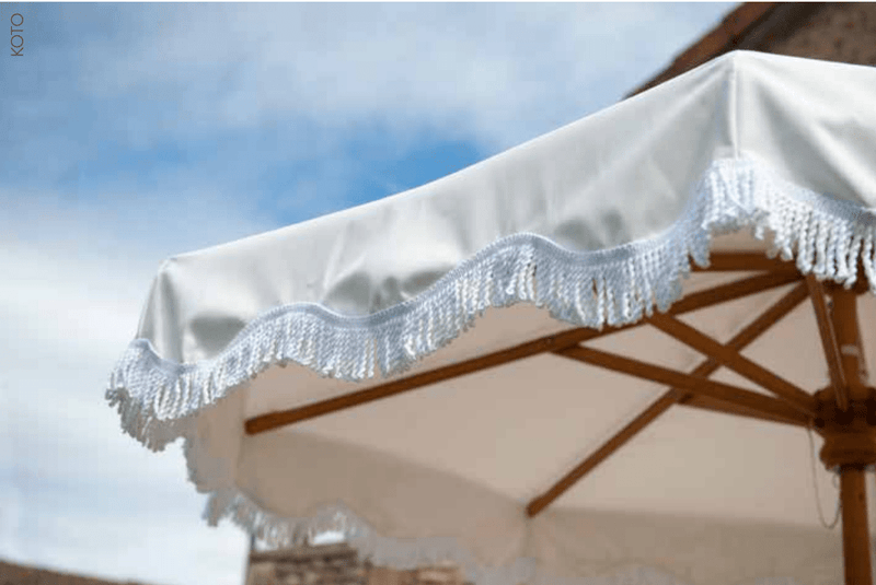 Load image into Gallery viewer, Fermob KOTO teak parasol with fringe, available in Ø200 and Ø250cm, ideal for outdoor shading and stylish patio decor.
