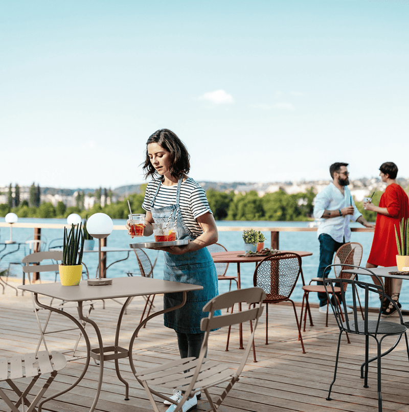 Load image into Gallery viewer, Fermob LA MÔME Chai folding chair in vibrant orange, lightweight metal design, perfect for outdoor seating and easy portability.

