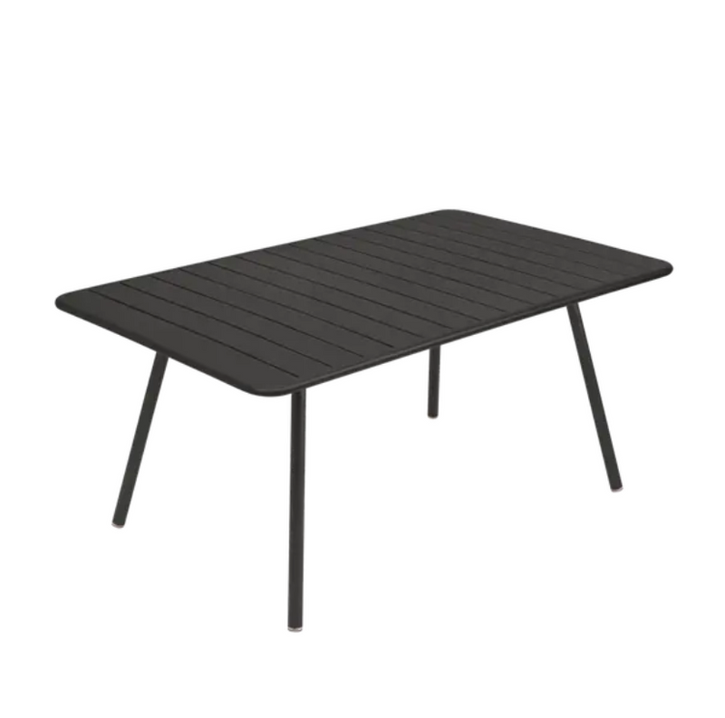 Load image into Gallery viewer, Luxembourg metal outdoor table in liquorice blue by Fermob, measuring 165 x 100 cm, shown in a patio setting.

