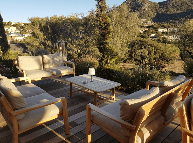 Load image into Gallery viewer, Lodge Low Armchair Teak - Custom Wood DesignsFermob Lodge low armchair for outdoor teak seating, shown on hotel terrace with stylish, weather-resistant design.Armchair Outdoor Teak24575192652279BeigeChevron
