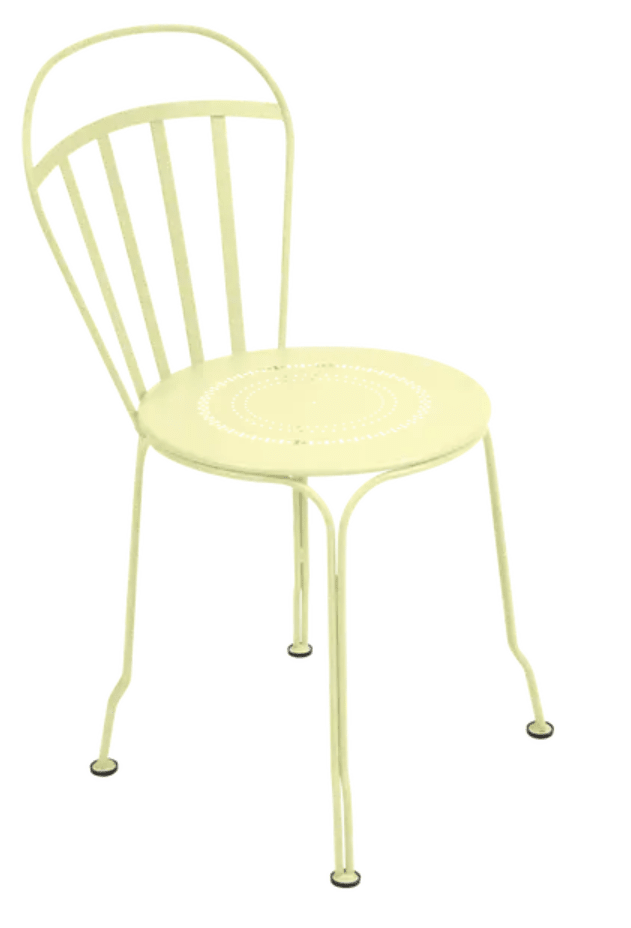 Load image into Gallery viewer, Fermob Louvre outdoor chair with frosted lemon color, featuring a stylish metal design and armrests for outdoor seating.
