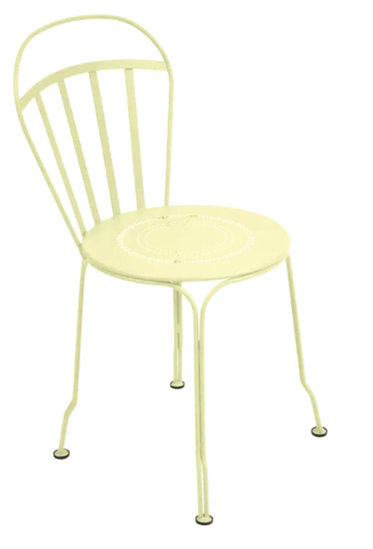 Fermob Louvre outdoor chair with frosted lemon color, featuring a stylish metal design and armrests for outdoor seating.