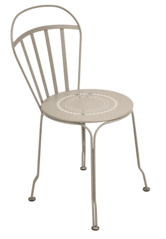 Nutmeg Fermob Louvre outdoor chair with curved metal frame and slatted seat, perfect for garden or patio seating.
