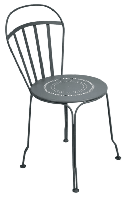 Storm grey Fermob Louvre outdoor chair with a sleek, modern design, featuring a curved seat and slender metal legs.